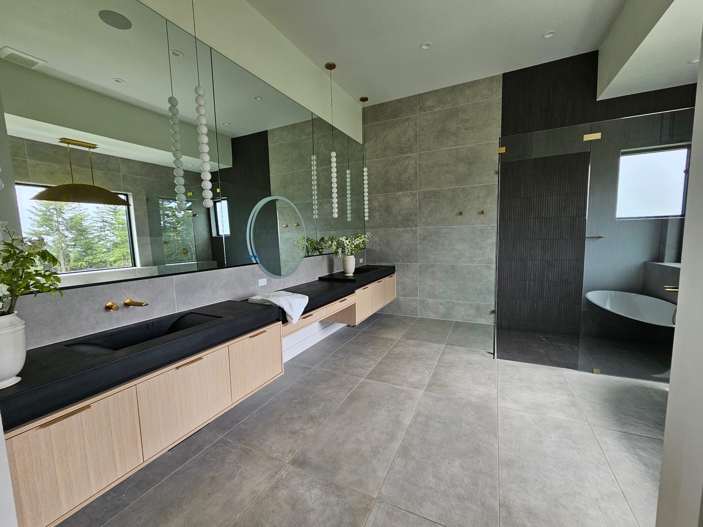 Floating vanity, floor-to-ceiling tile by Artemidas Renovation, Loganville