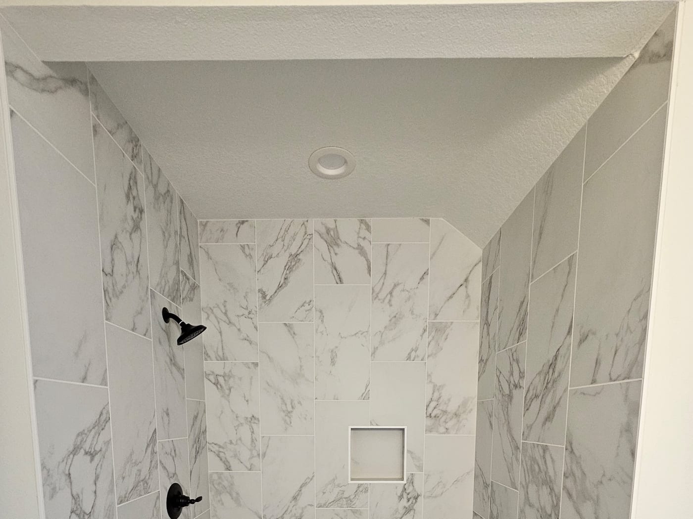 Book-matched marble, hex-tile floor by Artemidas Renovation, Loganville