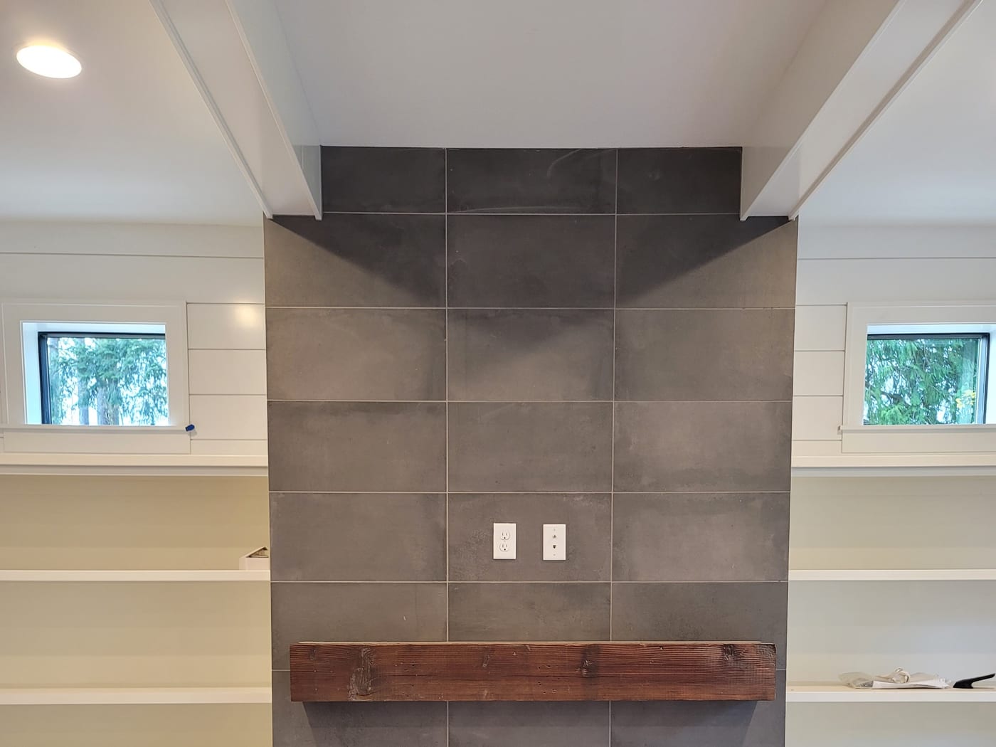 A tiled surround with custom cabinetry by Artemidas Renovation, Loganville